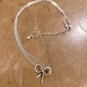 Delicate bow charm and chain with faux pearl accents